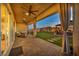 Inviting covered patio with ceiling fans, curtains, ample seating, and seamless access to the lush backyard at 6325 Gambetta St, Las Vegas, NV 89115
