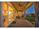 Inviting covered patio with ceiling fans, curtains, ample seating, and seamless access to the lush backyard at 6325 Gambetta St, Las Vegas, NV 89115