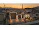 Lovely single-story home with a tile roof, two-car garage, and inviting front patio, illuminated by the warm sunset at 6325 Gambetta St, Las Vegas, NV 89115