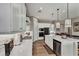 Bright, modern kitchen featuring white cabinetry, stainless steel appliances, and a central island with bar seating at 6325 Gambetta St, Las Vegas, NV 89115
