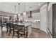 Well-lit kitchen with a large island, stylish pendant lights, modern appliances, and seamless flow into the dining space at 6325 Gambetta St, Las Vegas, NV 89115