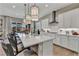Open kitchen boasts a large island with white quartz countertops and stylish pendant lighting at 6325 Gambetta St, Las Vegas, NV 89115