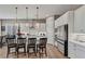 Contemporary kitchen with white cabinets, stainless steel appliances, island with seating, and natural light at 6325 Gambetta St, Las Vegas, NV 89115