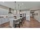 Bright, modern kitchen featuring a large island with seating, stainless steel appliances, and sleek white cabinetry at 6325 Gambetta St, Las Vegas, NV 89115
