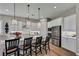 Bright, modern kitchen features a large island with bar seating and stainless steel appliances at 6325 Gambetta St, Las Vegas, NV 89115