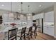 Stylish kitchen with white cabinets, stainless steel appliances, a large island, and elegant pendant lighting at 6325 Gambetta St, Las Vegas, NV 89115