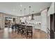 Bright, open kitchen featuring a large island with pendant lighting, modern appliances, and a view into the dining area at 6325 Gambetta St, Las Vegas, NV 89115