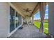 Spacious covered patio with outdoor seating, ceiling fans, and views of the lush green backyard at 6325 Gambetta St, Las Vegas, NV 89115