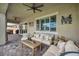 Inviting patio area with comfortable seating, stylish decor, and a ceiling fan for warm days at 6325 Gambetta St, Las Vegas, NV 89115