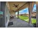 Covered patio with ceiling fans, outdoor seating, string lights, and a view of the beautifully landscaped backyard at 6325 Gambetta St, Las Vegas, NV 89115