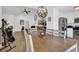 Bright dining area with modern light fixture and stylish wooden dining table at 656 Thornewood Pl, Las Vegas, NV 89123