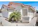 Close-up of the home's corner featuring stucco, desert landscaping, and a bay window at 656 Thornewood Pl, Las Vegas, NV 89123