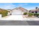 Charming one-story home featuring a red tile roof, a two-car garage and well-maintained landscaping at 656 Thornewood Pl, Las Vegas, NV 89123