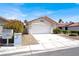 Charming single-story home featuring a red tile roof, a two-car garage and well-maintained landscaping at 656 Thornewood Pl, Las Vegas, NV 89123