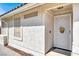A close-up of a home's front entrance featuring a white security door and textured walls at 656 Thornewood Pl, Las Vegas, NV 89123
