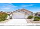 Charming single-story home with a classic garage door, red tile roof, and desert landscaping at 656 Thornewood Pl, Las Vegas, NV 89123