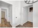 Bright hallway with multiple doorways, laminate flooring, and closet for storage at 656 Thornewood Pl, Las Vegas, NV 89123