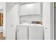 Laundry room with washer, dryer, and overhead storage cabinets at 656 Thornewood Pl, Las Vegas, NV 89123
