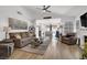 Bright living room with hardwood floors, ceiling fan and vaulted ceilings open to dining area at 656 Thornewood Pl, Las Vegas, NV 89123