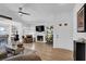 Open-concept living room with fireplace, ceiling fan, and lots of natural light at 656 Thornewood Pl, Las Vegas, NV 89123
