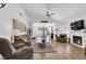 Comfortable living room with fireplace, television, and modern décor with lots of natural light at 656 Thornewood Pl, Las Vegas, NV 89123