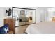 Main bedroom reflecting a mirrored closet, neutral decor and bathroom at 656 Thornewood Pl, Las Vegas, NV 89123
