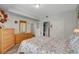 Comfortable bedroom with floral bedding, wood dresser, and convenient closet space at 6868 Sky Pointe Dr # 1089, Las Vegas, NV 89131