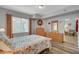 Cozy bedroom featuring a floral patterned quilt, light wood floors and view to the outside at 6868 Sky Pointe Dr # 1089, Las Vegas, NV 89131