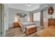 Relaxing bedroom features floral bedding, wood furniture, and ample natural light at 6868 Sky Pointe Dr # 1089, Las Vegas, NV 89131