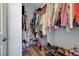Walk-in closet with wood-look floor, shelving with an abundance of items and supplies at 6868 Sky Pointe Dr # 1089, Las Vegas, NV 89131