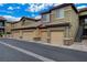 View of condominiums with attached garages and stairs to upper units at 6868 Sky Pointe Dr # 1089, Las Vegas, NV 89131