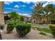 Landscaped condominium complex with grassy areas, bushes, and gravel groundcover at 6868 Sky Pointe Dr # 1089, Las Vegas, NV 89131