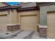Close up street view of condo garages, neutral paint and stone accents at 6868 Sky Pointe Dr # 1089, Las Vegas, NV 89131