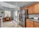 Bright kitchen features stainless steel refrigerator, dining area, and sliding glass door to the patio at 6868 Sky Pointe Dr # 1089, Las Vegas, NV 89131