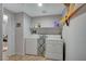 Functional laundry room with appliances and shelf storage at 6868 Sky Pointe Dr # 1089, Las Vegas, NV 89131