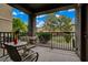 Outdoor patio featuring table and chairs, and black metal railing with community views at 6868 Sky Pointe Dr # 1089, Las Vegas, NV 89131