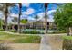Community pool with palm trees and desert landscaping, fenced for safety at 6868 Sky Pointe Dr # 1089, Las Vegas, NV 89131