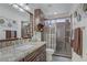 Elegant bathroom with a granite countertop, dark wood cabinets, and a glass-enclosed shower for a modern feel at 7013 Bisoni St, Las Vegas, NV 89149