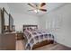 Inviting bedroom featuring a plaid-covered bed, matching nightstands, and a ceiling fan for added comfort at 7013 Bisoni St, Las Vegas, NV 89149
