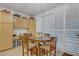 Bright breakfast nook featuring a round wood table, chairs, and built-in cabinets for extra storage at 7013 Bisoni St, Las Vegas, NV 89149