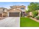 Inviting two-story home with a well-manicured lawn, a spacious driveway, and a secure courtyard gate enhancing curb appeal at 7013 Bisoni St, Las Vegas, NV 89149
