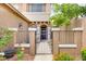 Charming home entrance with a gated courtyard, garden, and stylish exterior lighting at 7013 Bisoni St, Las Vegas, NV 89149