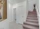 Bright hallway featuring carpeted stairs and access to various rooms, creating a welcoming entry at 7013 Bisoni St, Las Vegas, NV 89149