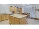 Bright kitchen with large island, natural wood cabinets, and stainless appliances at 7013 Bisoni St, Las Vegas, NV 89149