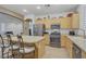 Modern kitchen with stainless steel appliances and a breakfast bar overlooking the living area at 7013 Bisoni St, Las Vegas, NV 89149
