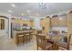 Well-lit kitchen with light wood cabinets and island seating at 7013 Bisoni St, Las Vegas, NV 89149