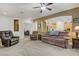 Bright living room with comfortable furniture and view into kitchen at 7013 Bisoni St, Las Vegas, NV 89149