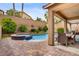 Backyard pool and spa with lush landscaping and covered patio at 7013 Bisoni St, Las Vegas, NV 89149