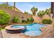 Backyard oasis features a pool, spa, rock waterfall, and lush landscaping at 7013 Bisoni St, Las Vegas, NV 89149