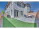 Inviting backyard featuring a paved patio area, lush artificial grass, and a cozy seating arrangement at 764 Aurora Vale Pl, Henderson, NV 89011